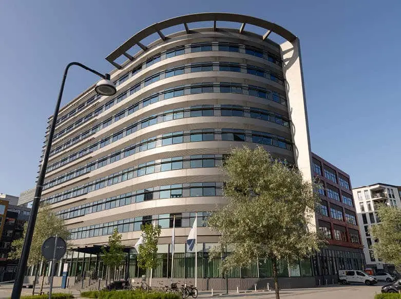 A modern office building with a curved façade.