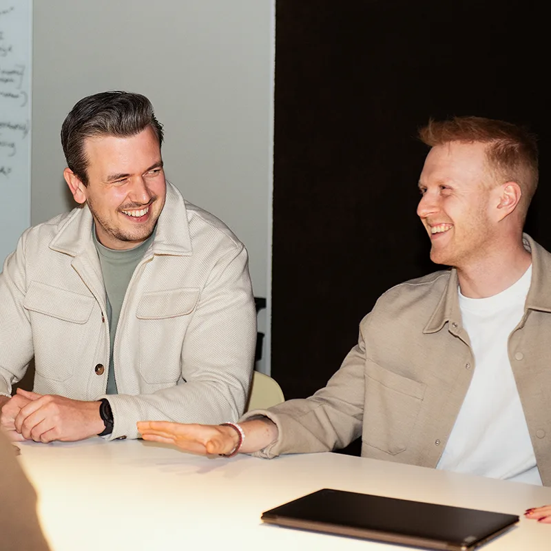 Two colleagues talking at a table